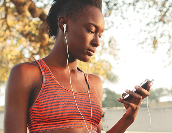 - Girl in tiger striped sports bra holding phone